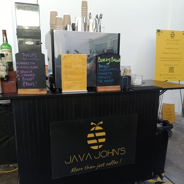 The Java John's coffee van with its chalkboard menu at an event