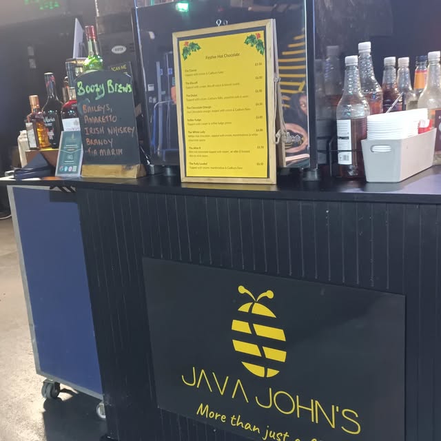 Inside the Java John's coffee van with the menu board