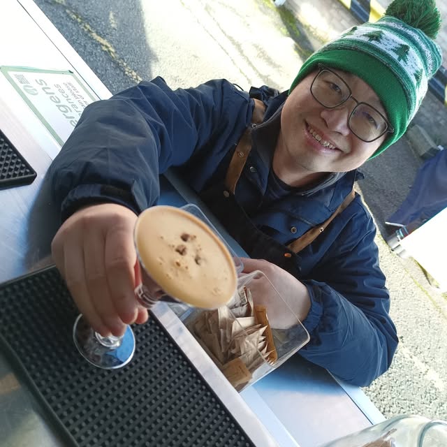 A Java John's barista serving a fresh coffee